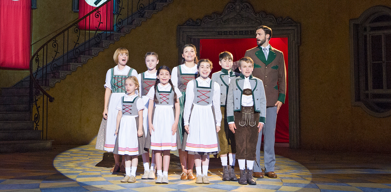 Charlotte Wakefield (Maria), far left and Michael Xavier (Captain von Trapp), far right in The Sound Of Music at Regent's Park Open Air Theatre. Photo: Tristram Kenton