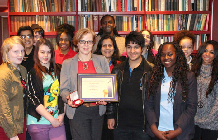 Jan Sharkey-Dodds receiving a Jack Petchey Foundation award with some of the young people she has worked with at Theatre Royal Stratford East