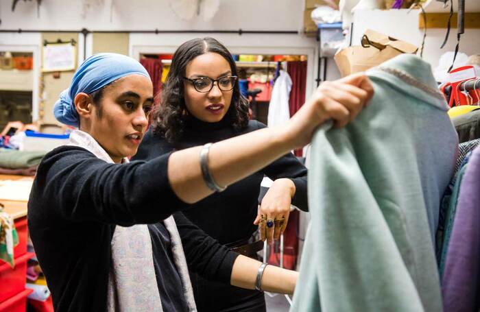 A design team discuss a garment in the costume room of a theatre. Photo: Alex Brenner/Tiata Fahodzi