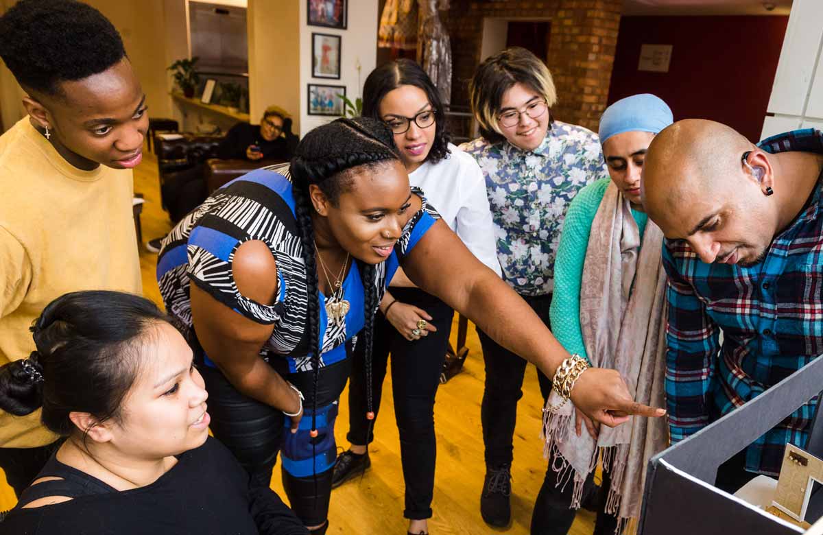 During a model-box presentation, a theatre company member asks the designer a question. Photo: Alex-Brenner/Tiata Fahodzi