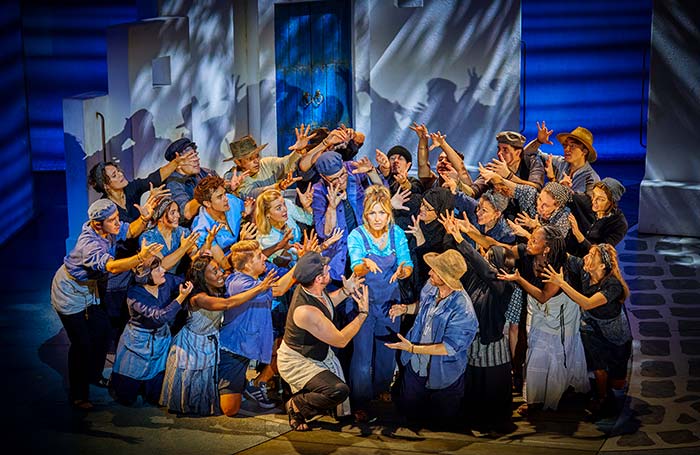 Mazz Murray as Donna with the cast in a London production of Mamma Mia!. Photo: Brinkhoff Moegenburg
