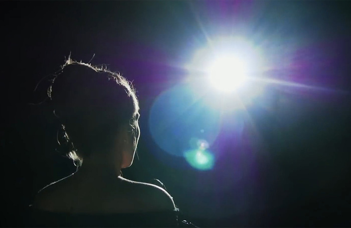 Opera singer in the spotlight. Photo: Shutterstock