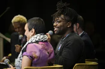 Fehinti Balogun smiling and talking on Climate Activist panel